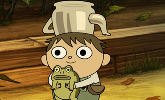 A short and squat child in green overalls with is wearing a silver teapot as a hat stands smiling, he is holding a small frog who looks to be emotionless.