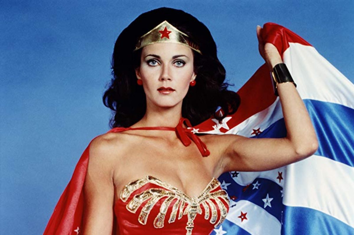 Linda Carter in her Wonder Woman outfit with a USA cape behind her