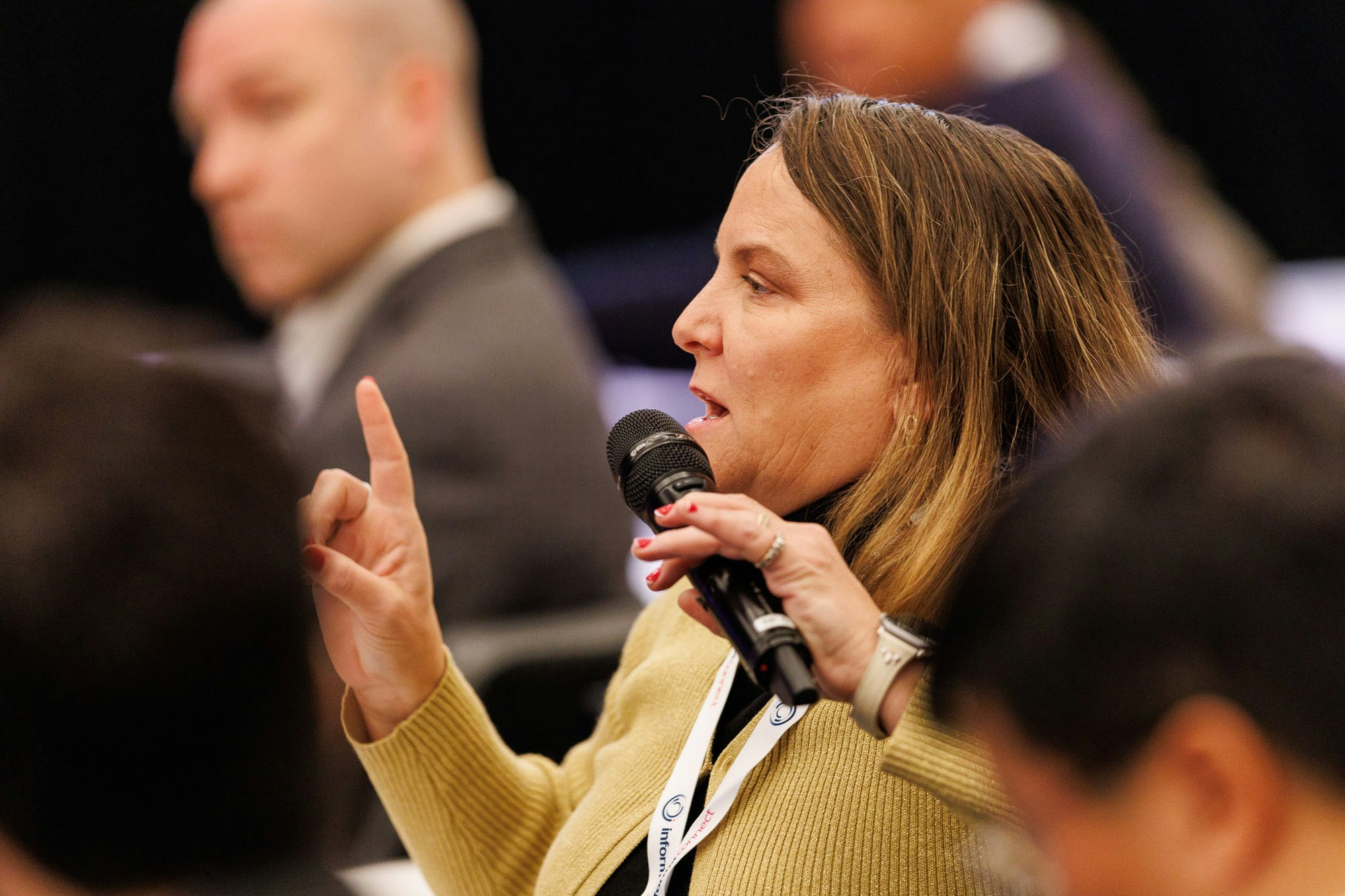 Woman asks a questions after a panel discussion at Trade and Channel Strategies