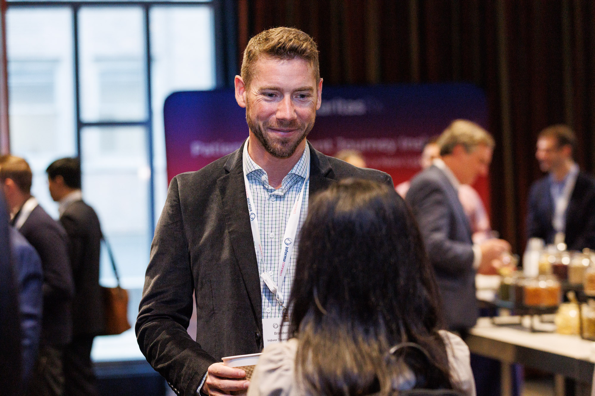 Two pharmaceutical professionals network at reception at Trade and Channel Strategies