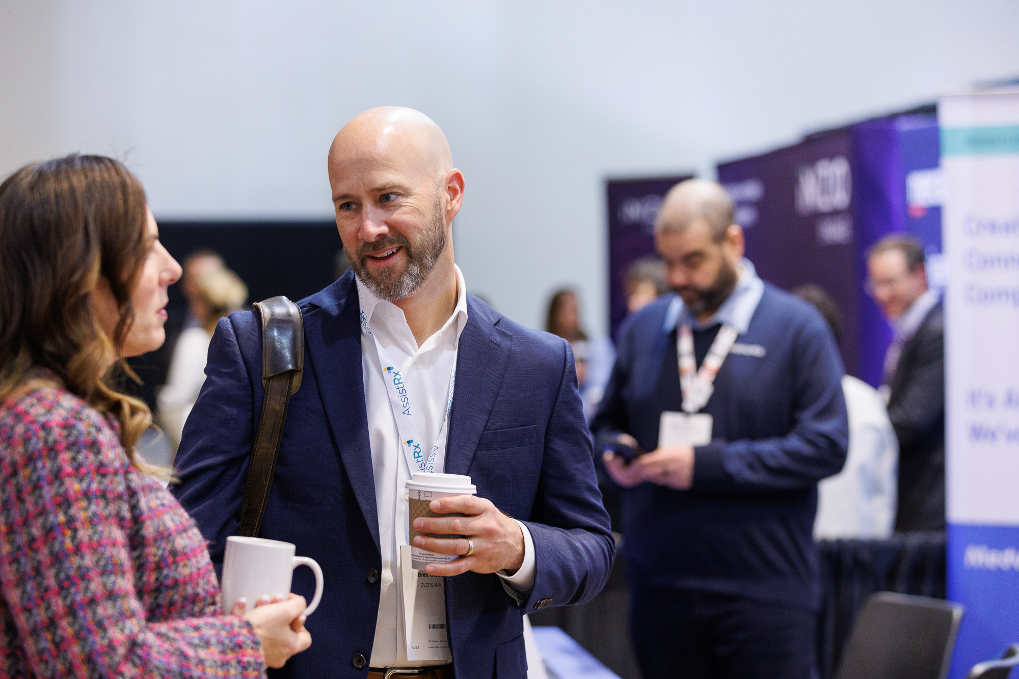 Pharmaceutical access professionals in conversation holding hot drinks at Access USA conference