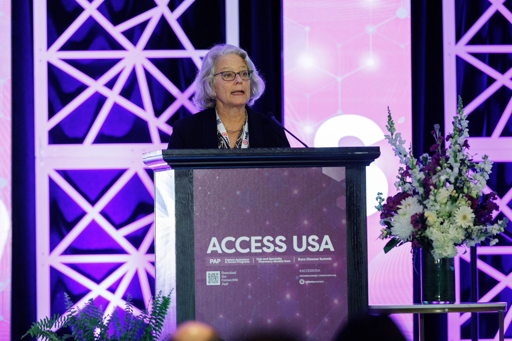 A female pharmaceutical professional addressing conference at Access USA