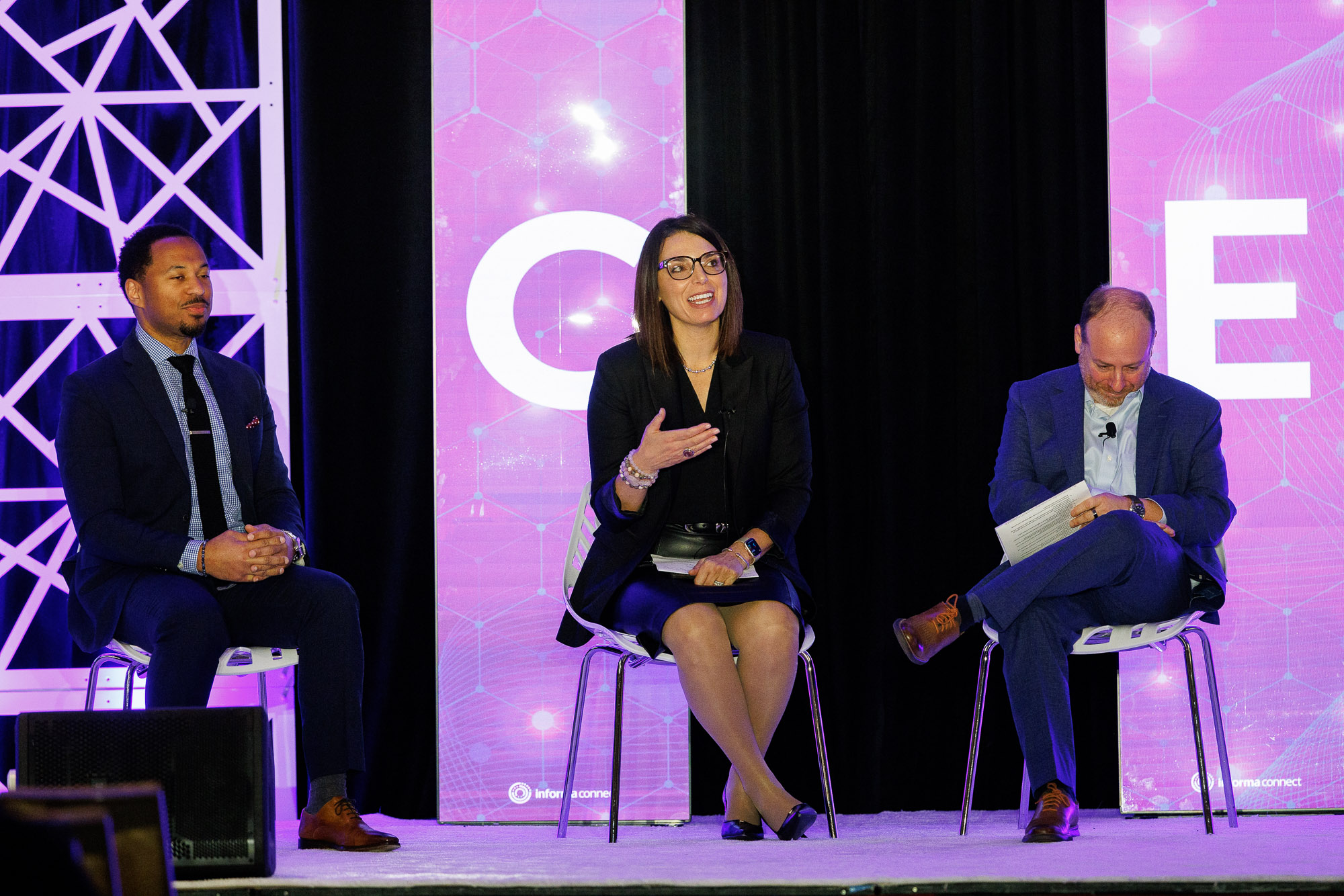 Three speakers on stage at Patient Assistance & Access Programs conference