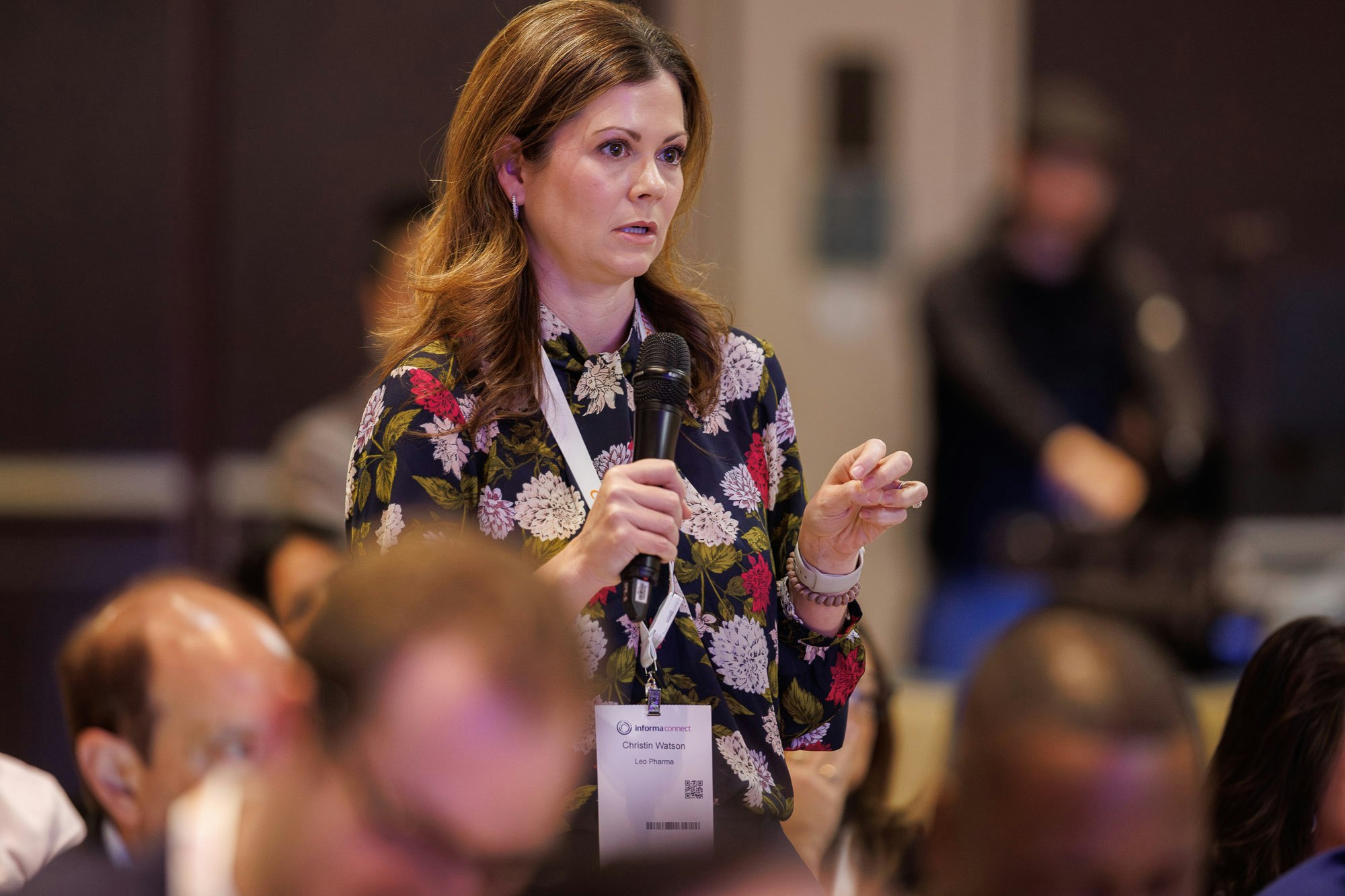 Attendee asking a question at pharma conference