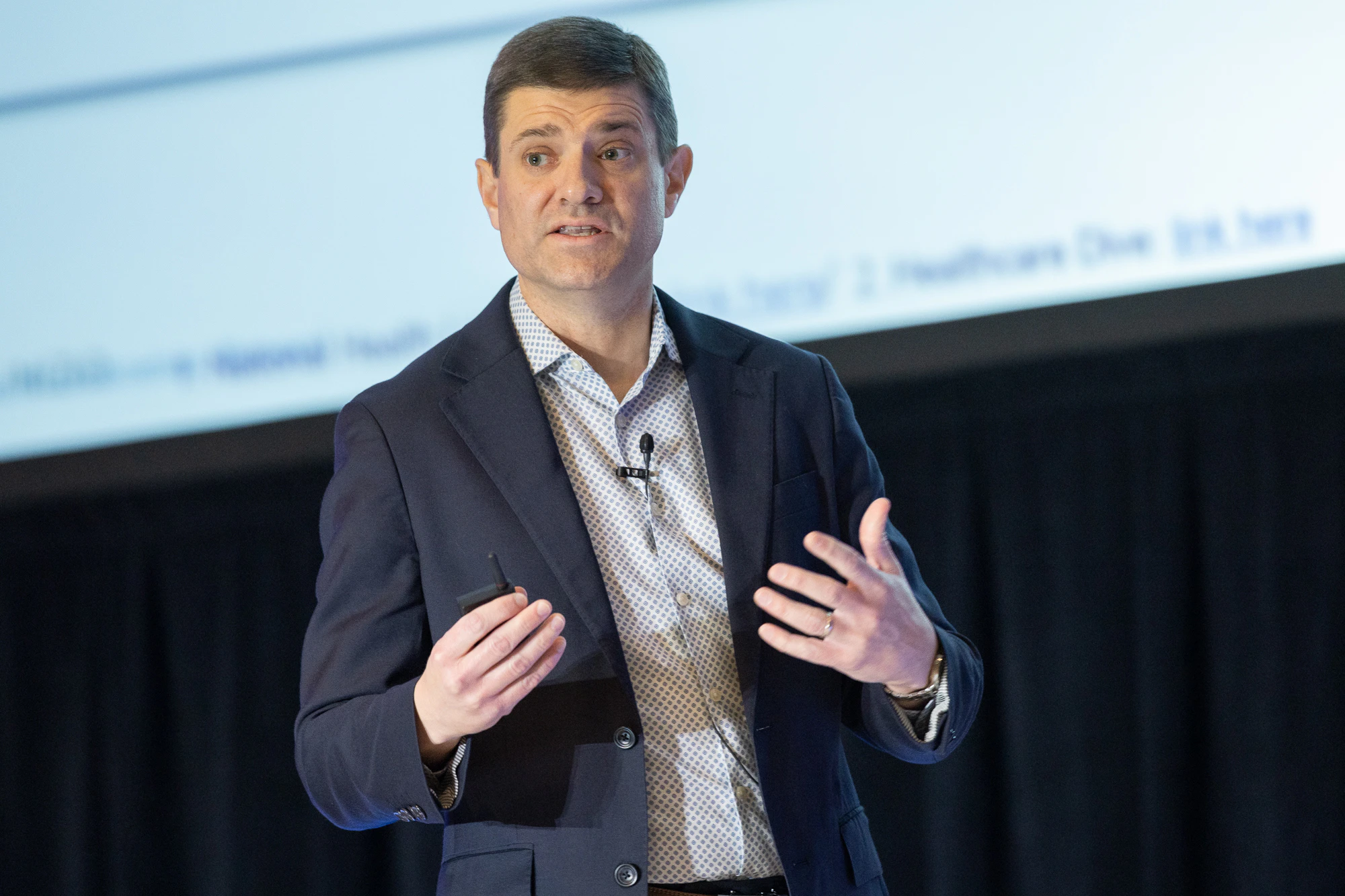 Corey Ford on stage at Patient Assistance & Access Programs