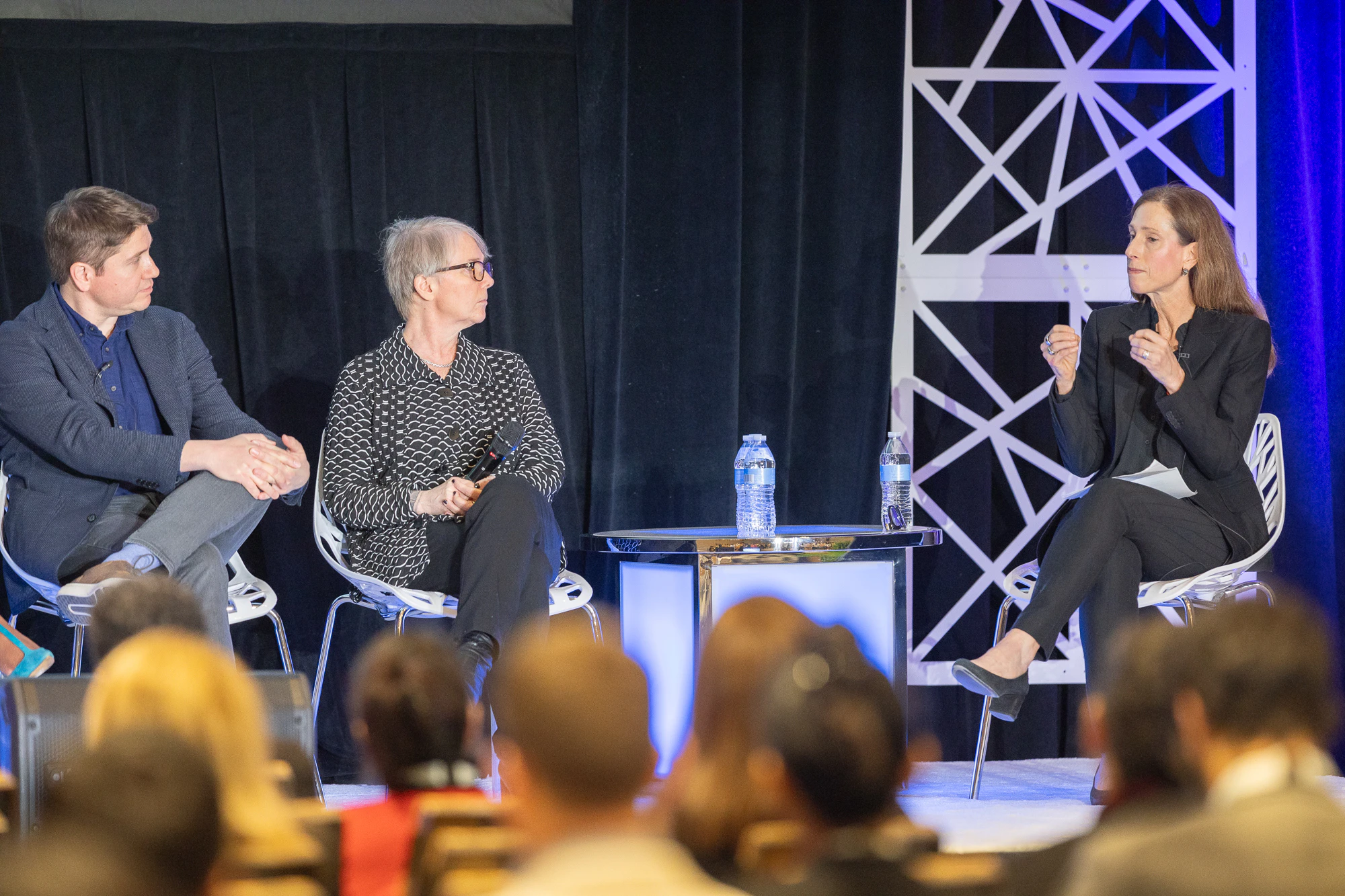 Pharmaceutical professionals on stage in a panel discussion at Patient Assistance & Access Programs