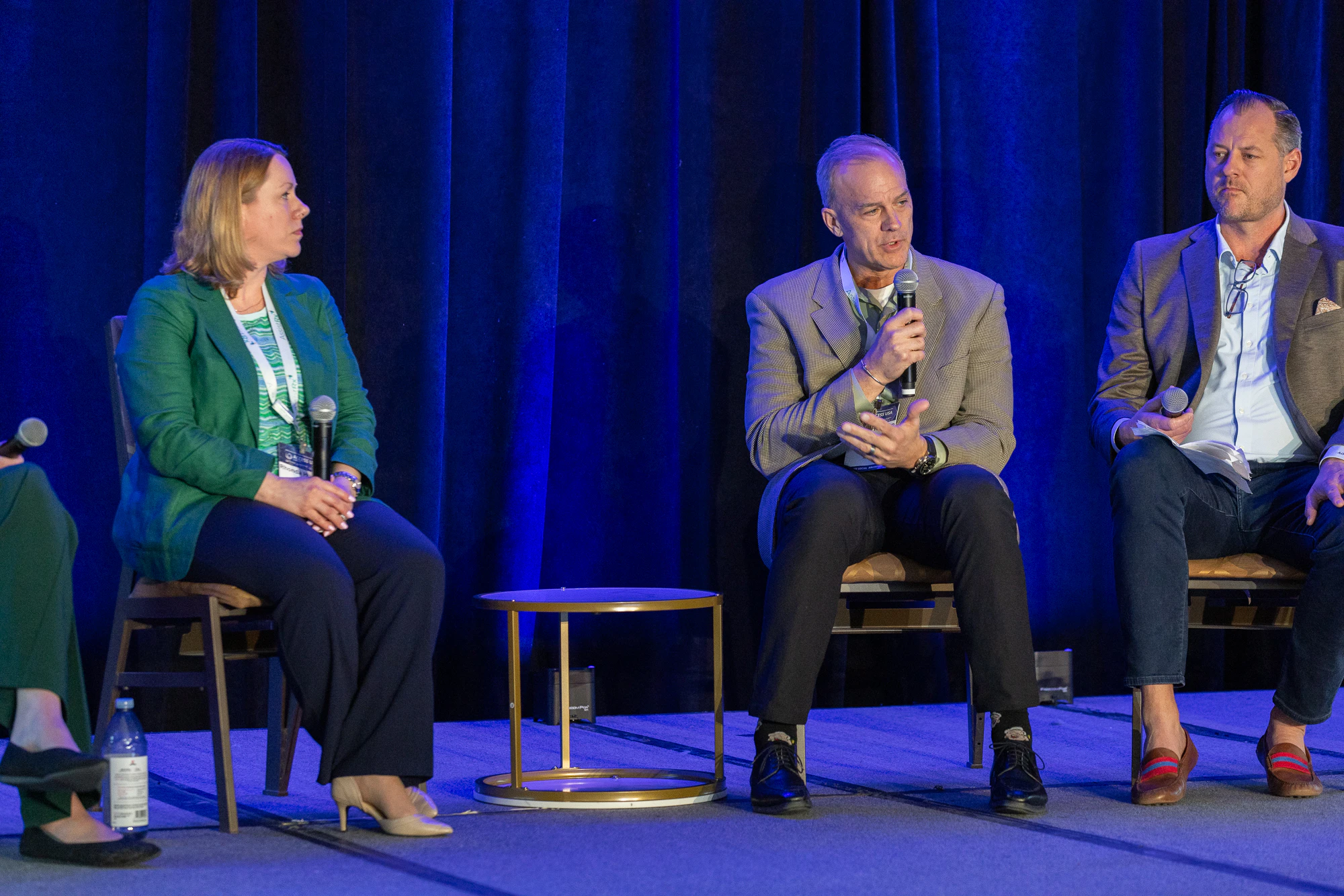 Three speakers on stage at Patient Assistance & Access Programs conference