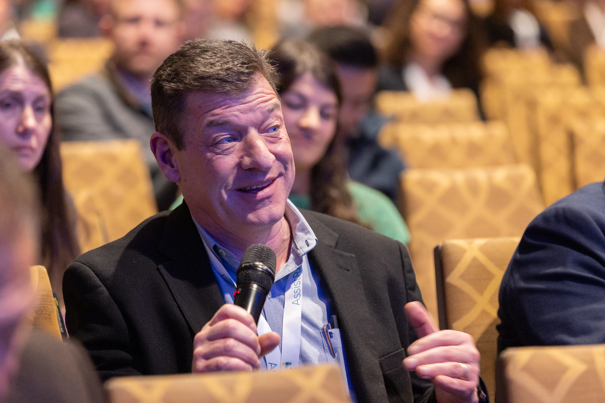 Attendee asking a question at Patient Assistance & Access Programs conference