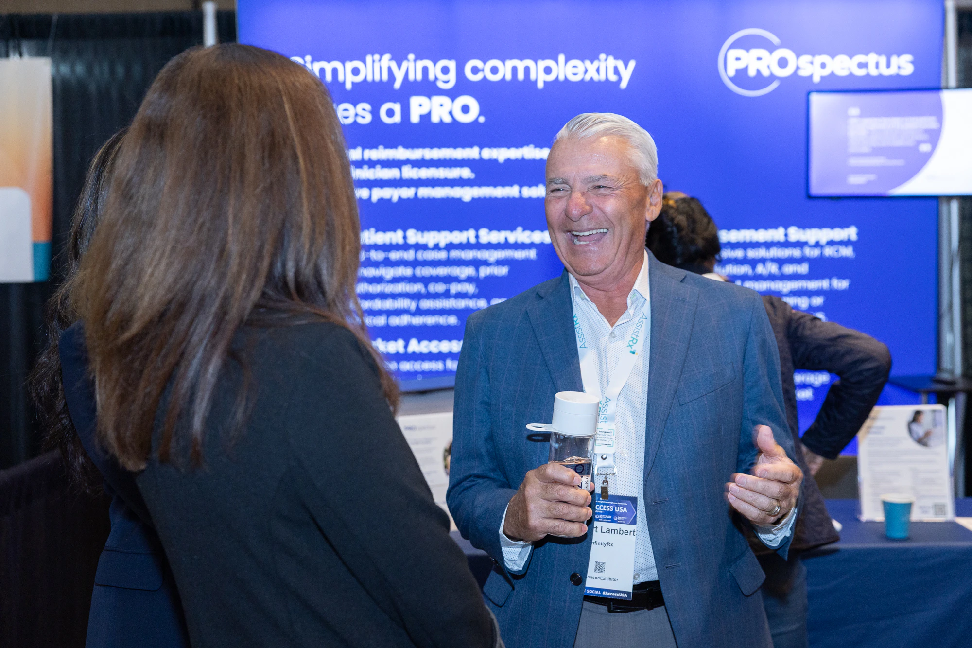 Exhibitors and attendees conversing at Patient Assistance & Access Programs