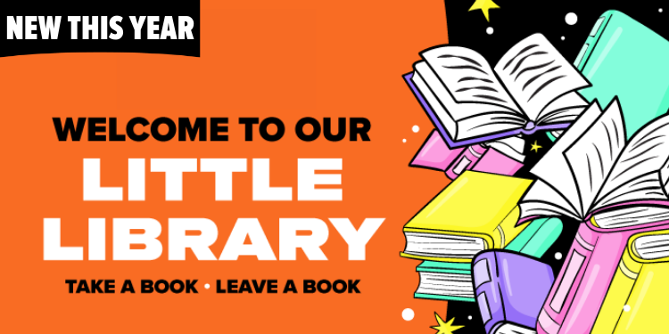 A woman with long dark hair and a tattoo on her forearm browses a shelf filled with comic books and graphic novels at a convention. She holds a book in her hands while smiling, and behind her, more shelves of books line the room.