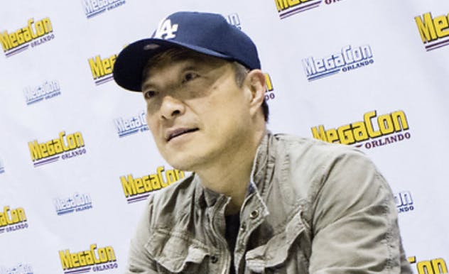 Jim Lee smiles on stage at MEGACON Orlando