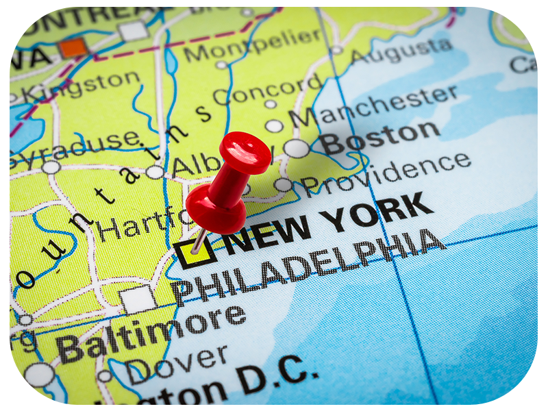 Pushpin pointing at New York city in USA