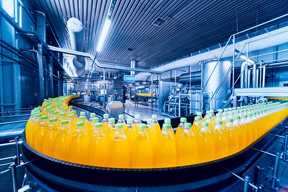 Beverage factory interior. Conveyor with bottles for juice or water. Equipments