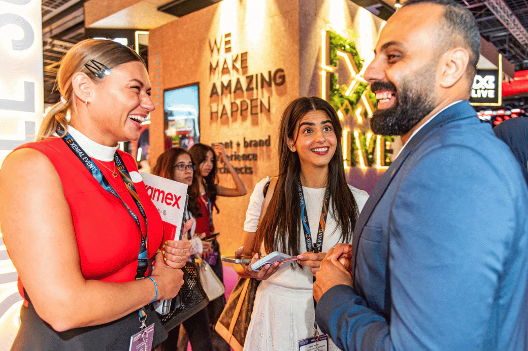 Exhibitors demonstrating interactive event technology to attendees at MEES, showcasing innovation at Dubai World Trade Centre.