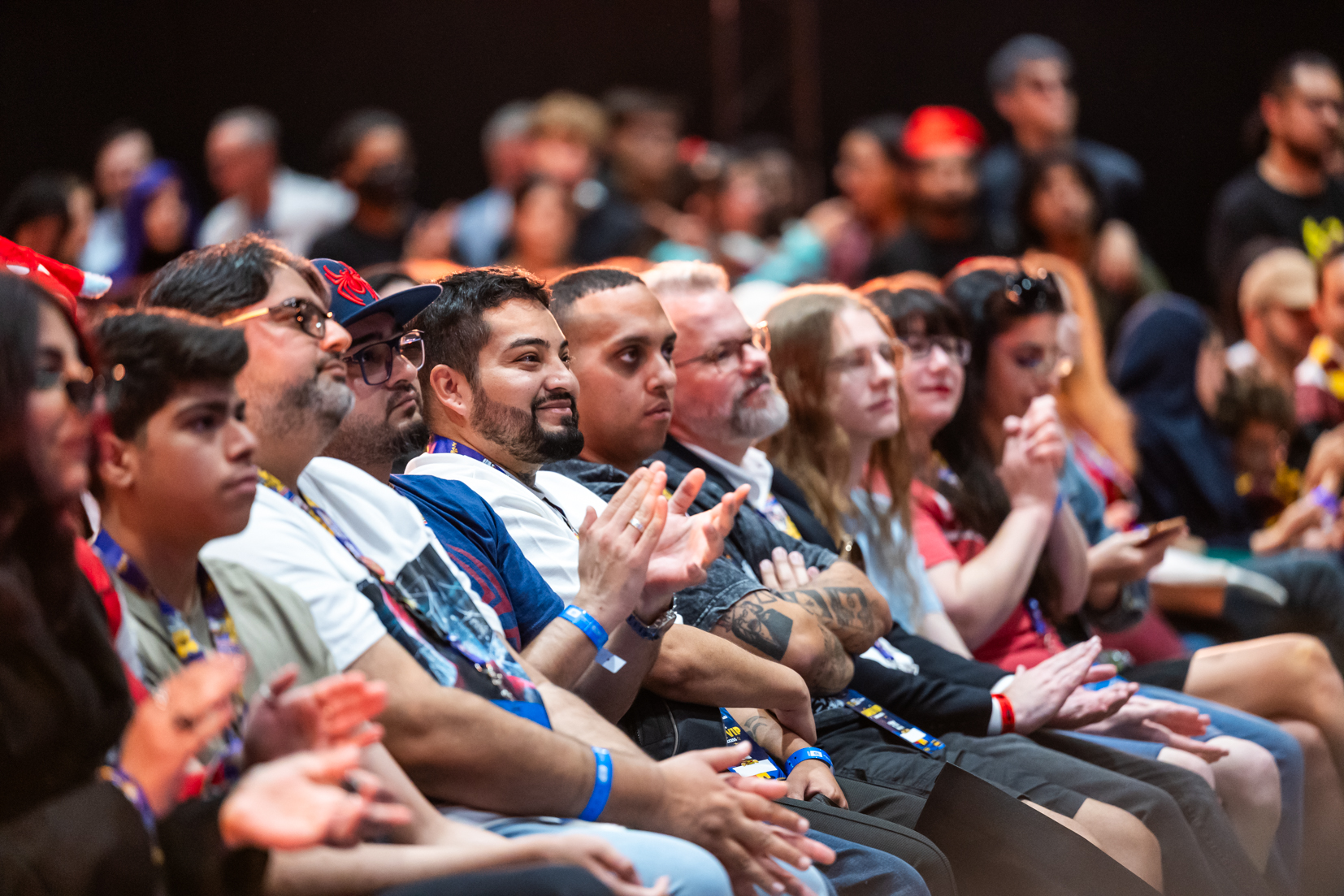 Close-up of a smiling audience enjoying a short film screening at MEFCC's Main Stage, reflecting emotional connection and enthusiasm.
