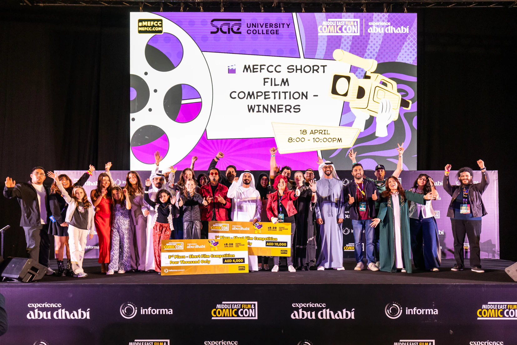 Audience in cosplay applauding and filming during a live screening at MEFCC, showcasing excitement and fan engagement at the Main Stage.