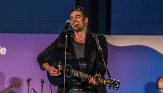 man playing guitar on stage