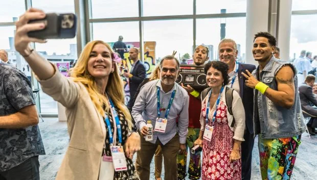 a group of men and women taking selfie