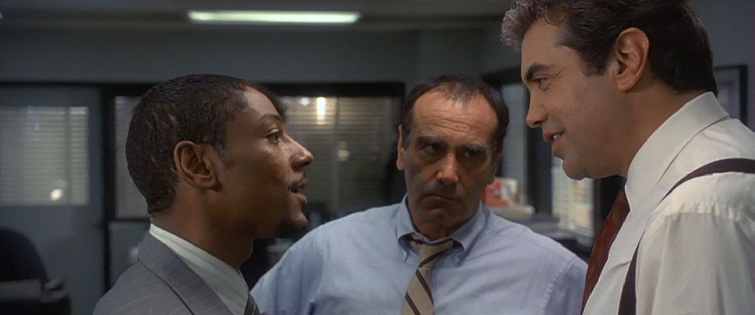 Giancarlo staring up at a guy confrontationally with another man in the middle eyeing the other guy.