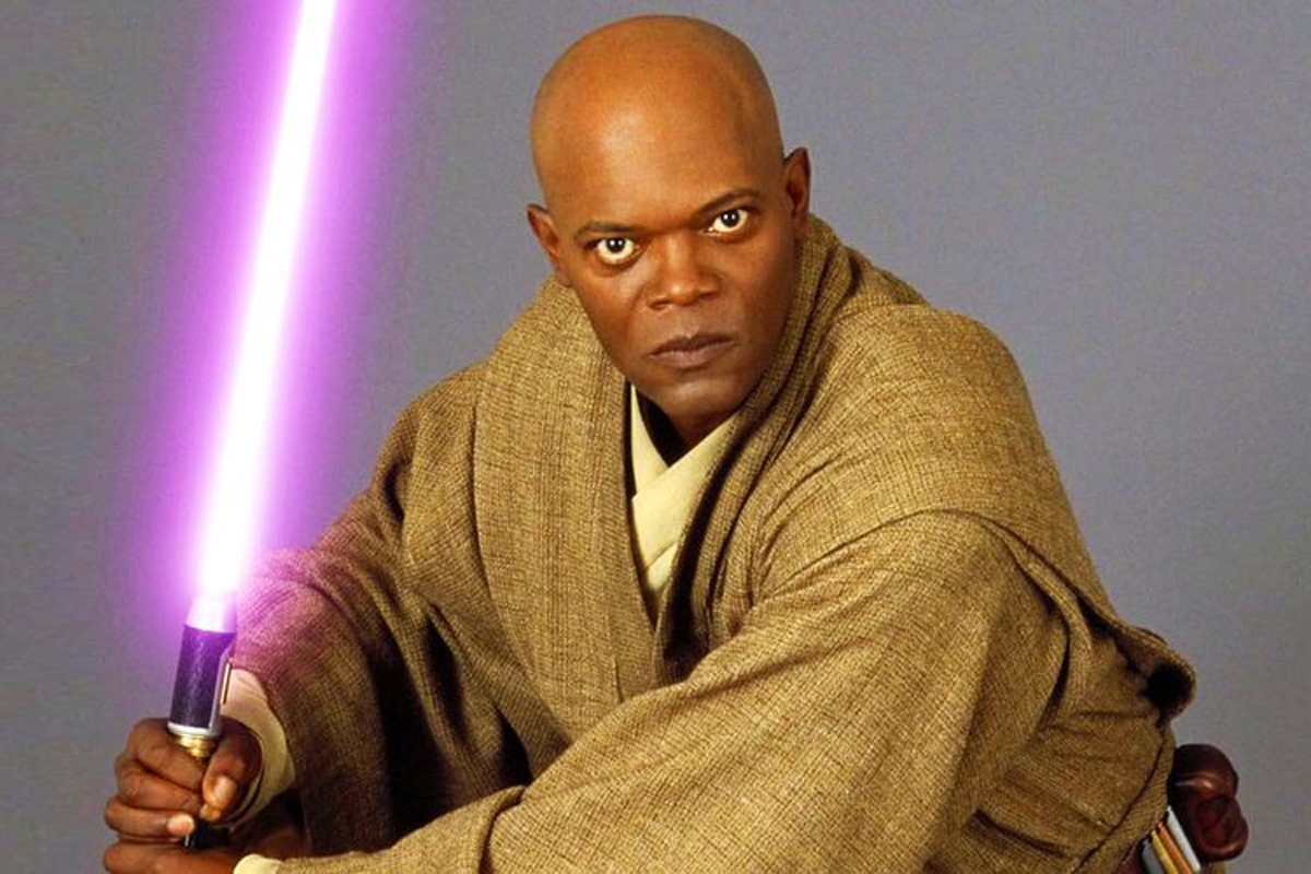 Macu Windu posing for the camera very seriously holding an ignited purple lightsaber with brown robes on