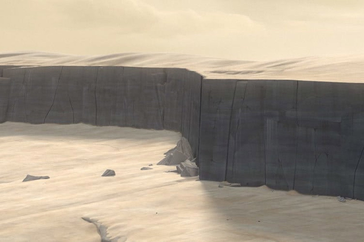 A barren desert with a giant cave opening in the midle