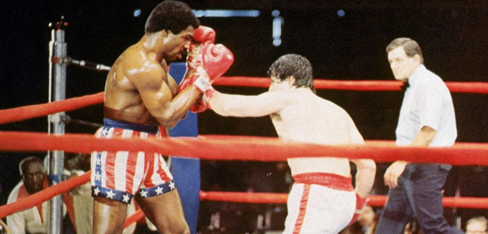 Carl Weathers wearing an American flag boxing shorts in the ring with Sylvester Stallone