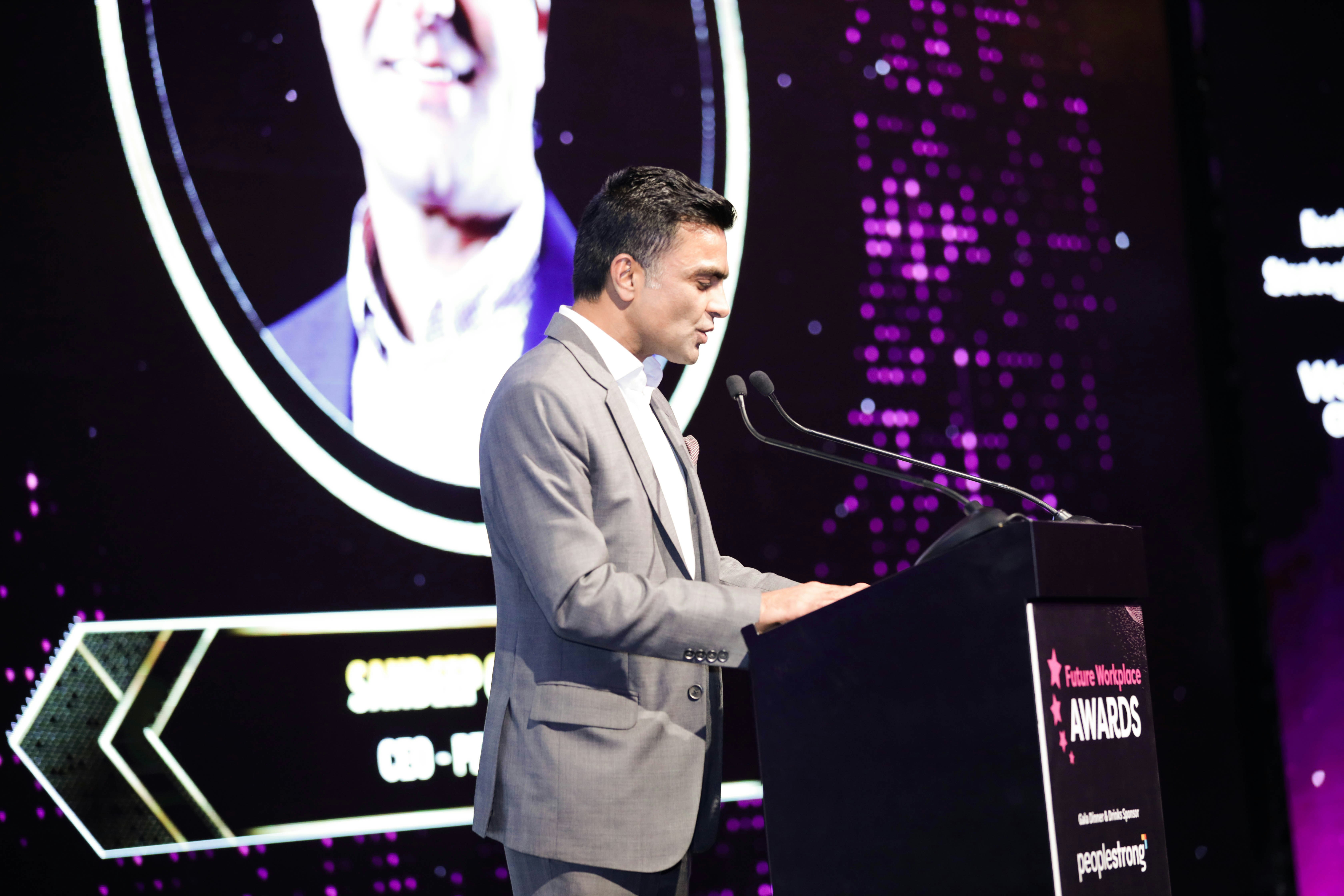 Speaker presenting on stage at the HRSE KSA Awards — recognising HR excellence and honouring teams for their contributions to workplace success