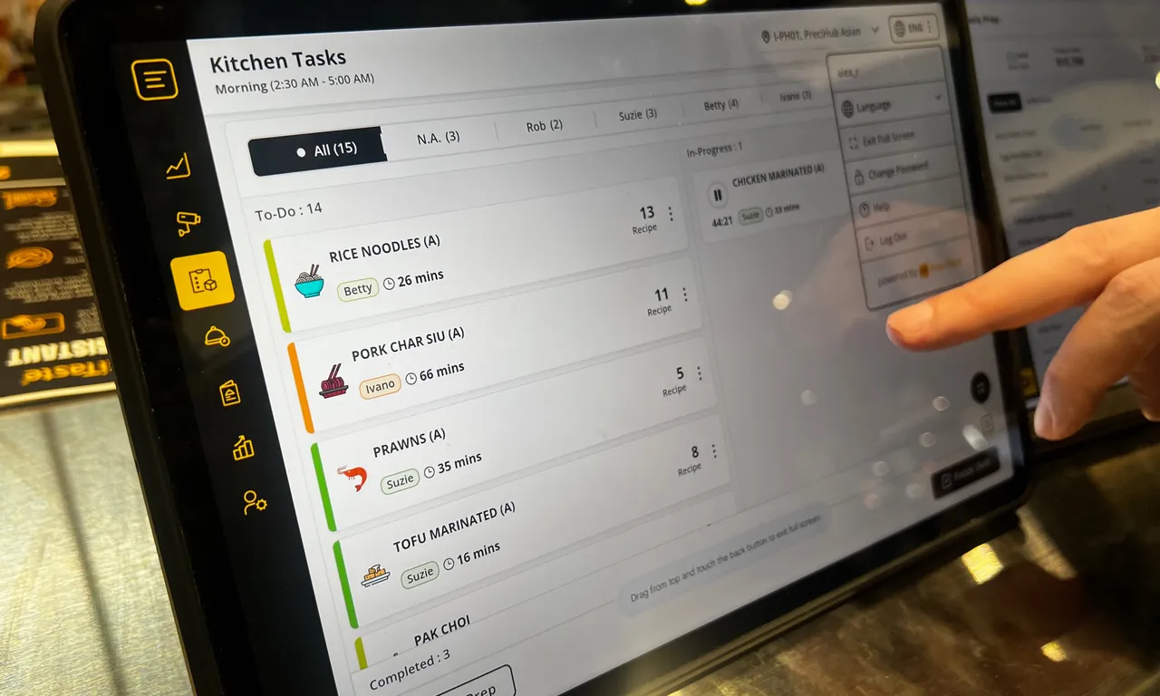 Employee manages Kitchen Tasks on a screen