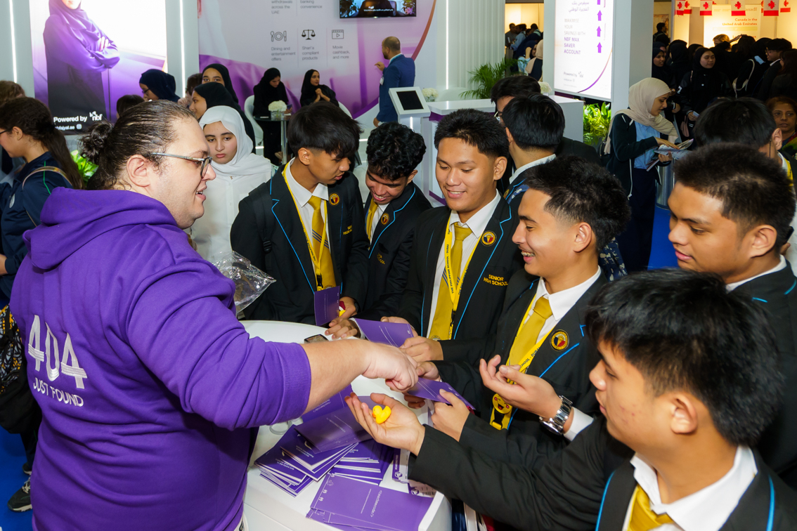University representative discusses scholarships and career pathways with students at Najah Dubai education expo.