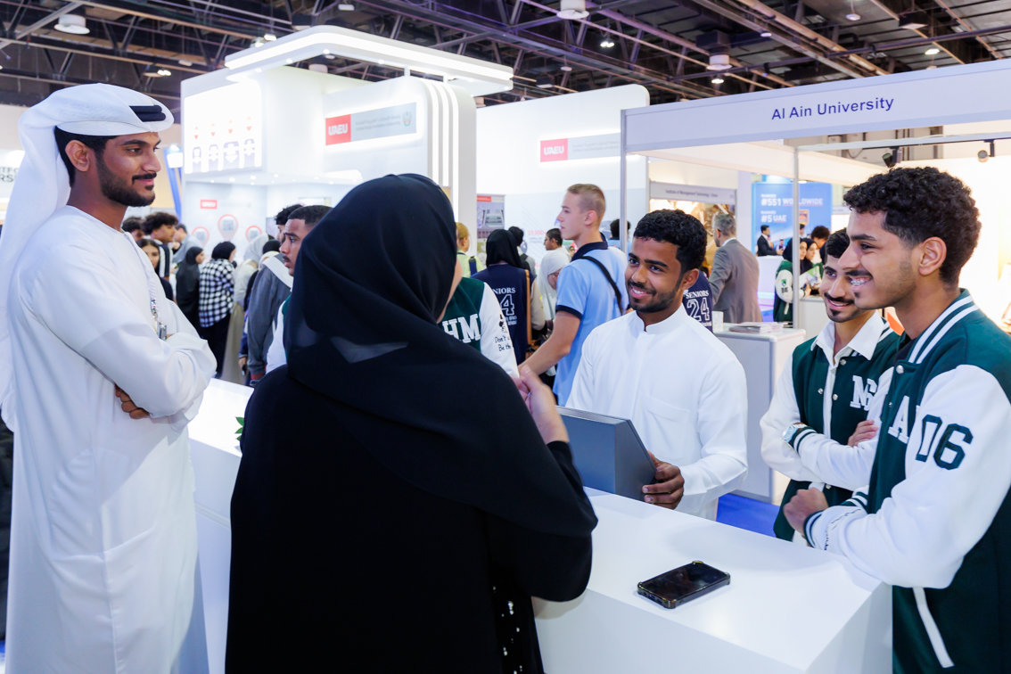 Students engage with Al Ain University representative at Najah Dubai 2025, UAE’s leading higher education fair.