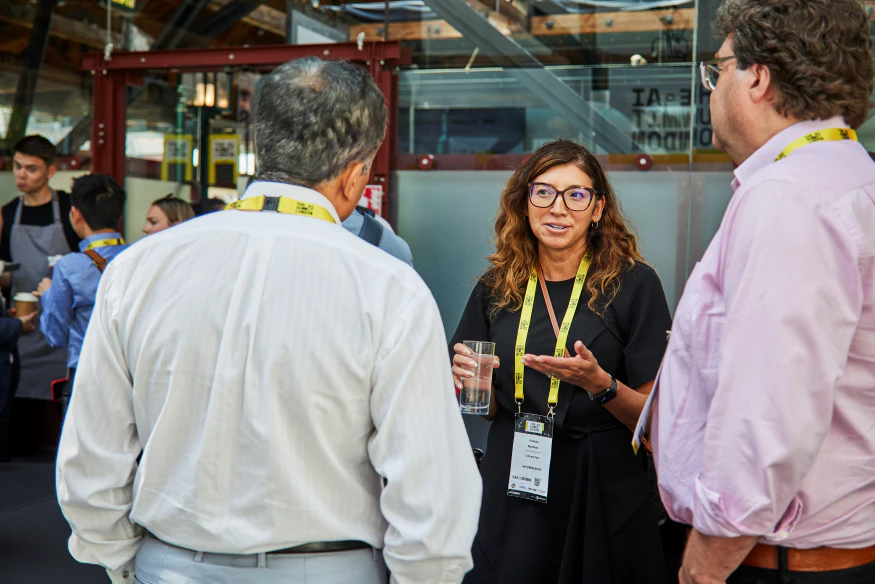People talk in the networking area at The AI Summit London