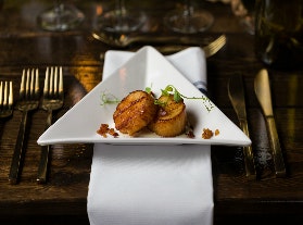 scallops in a triangular white plate