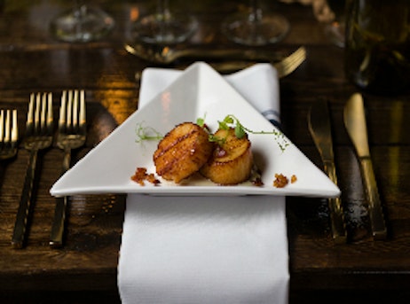 scallops in a triangular white plate