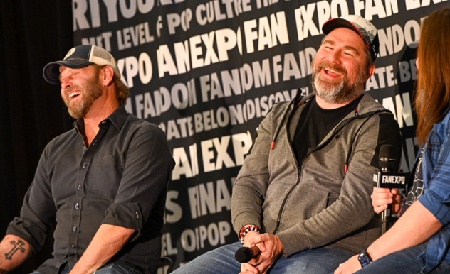 The image captures a lighthearted moment at a FAN EXPO panel, showing Rob Weithoff and Roger Clark laughing heartily. Rob, on the left, is wearing a dark gray shirt and a baseball cap and leans back in his chair, his laughter open and genuine. Roger, on the right, is in a gray hoodie and holding a microphone; he is also enjoying a good laugh, his eyes closed and head tilted back. This joyous scene reflects the fun and engaging atmosphere typical of fan conventions, where panel discussions often include humorous and entertaining interactions. The background is adorned with repeated text emphasizing the fan-centric nature of the event.