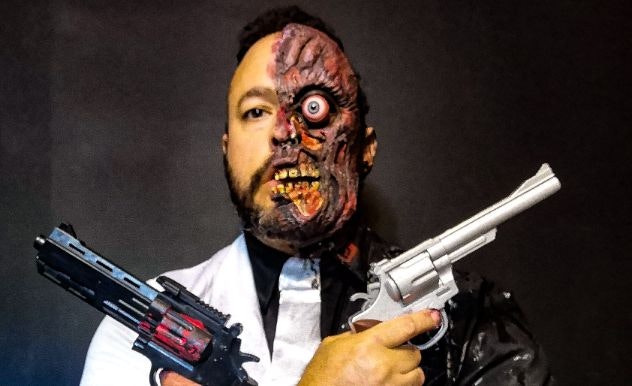Frank Coraci dressed as Two Face holding guns from Batman