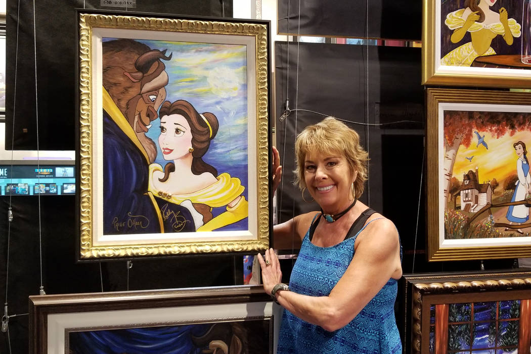 Paige O'Hara posing with her Belle painting