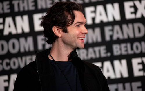 Ethan Peck smiling on stage