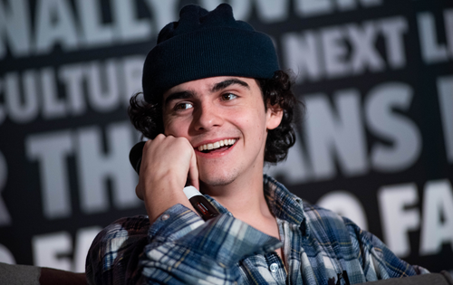 Jack Dylan Grazer laughing and looking off to his right