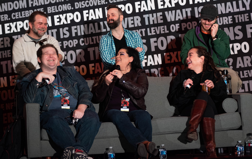 The cast of My Hero Academia laughing in a panel. From left to right: Justin Cook, Jesse Grelle, Ian Sinclair, Leah Clark, Trina Nishimura, and Kellen Goff