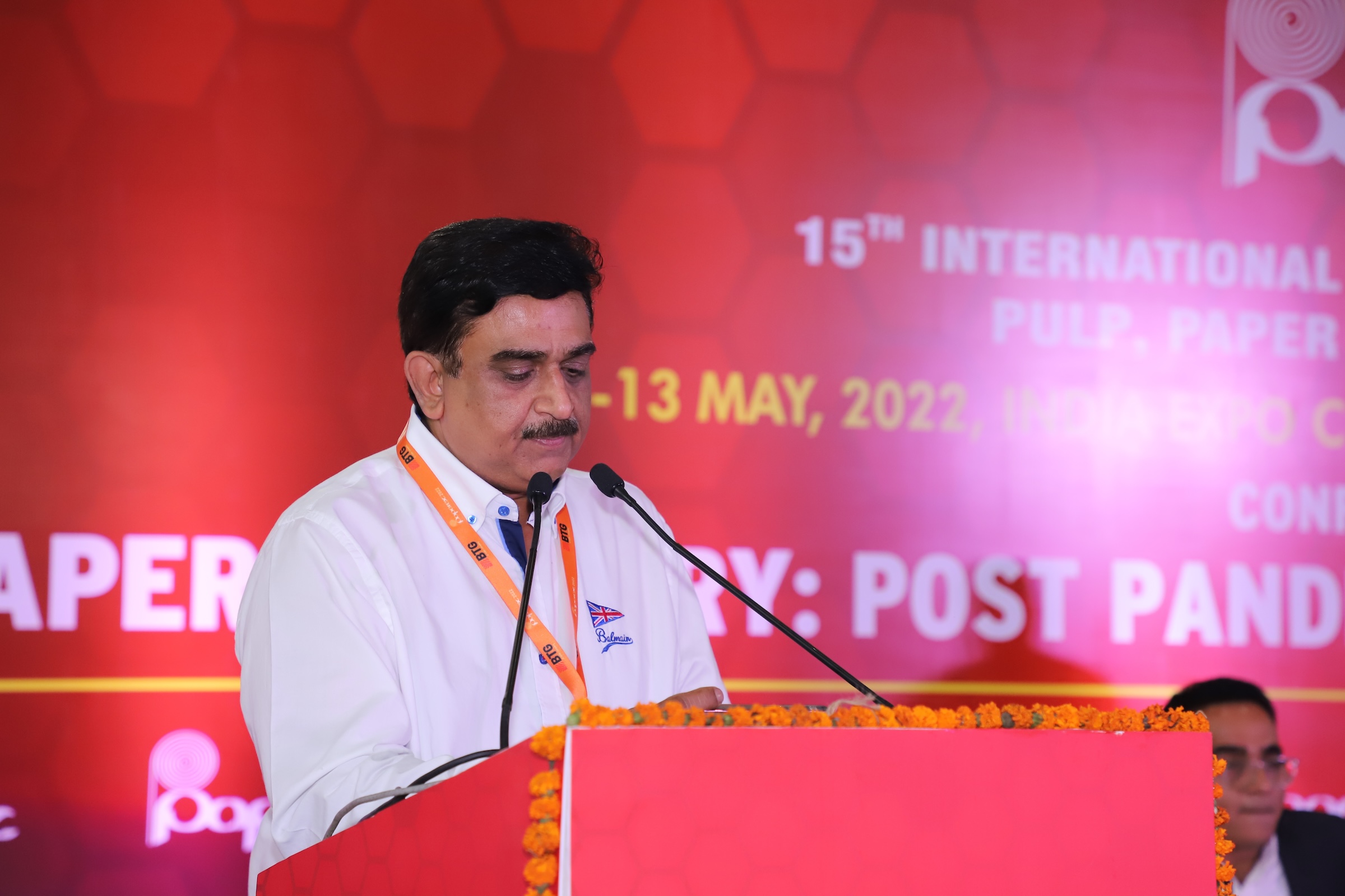 Speaker at podium during a session at Paperex