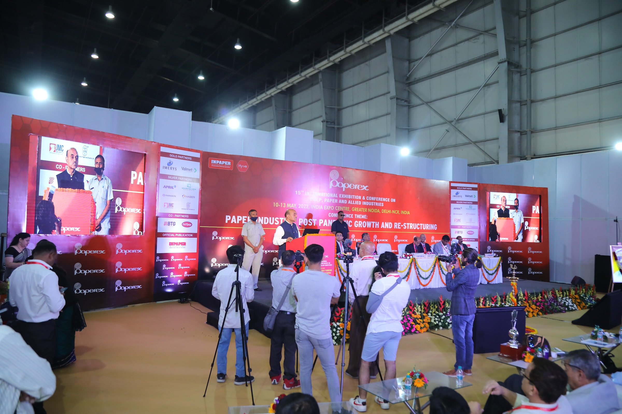 Photographers from various media capturing the conference session