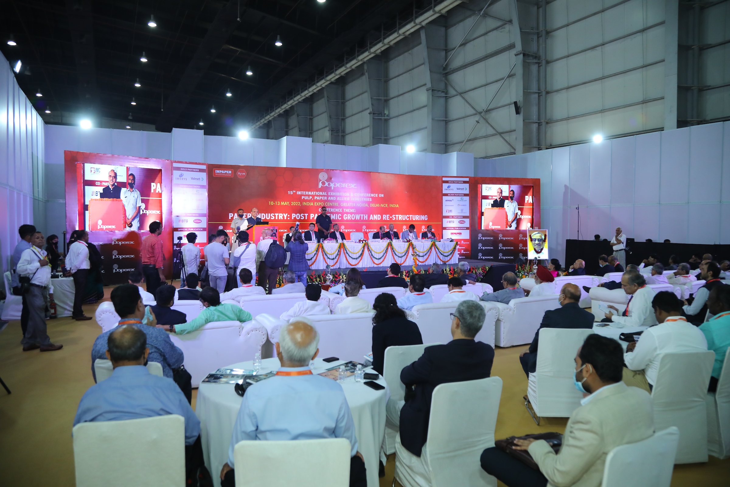 Rear view of a conference session showing the speaker addressing the attendees