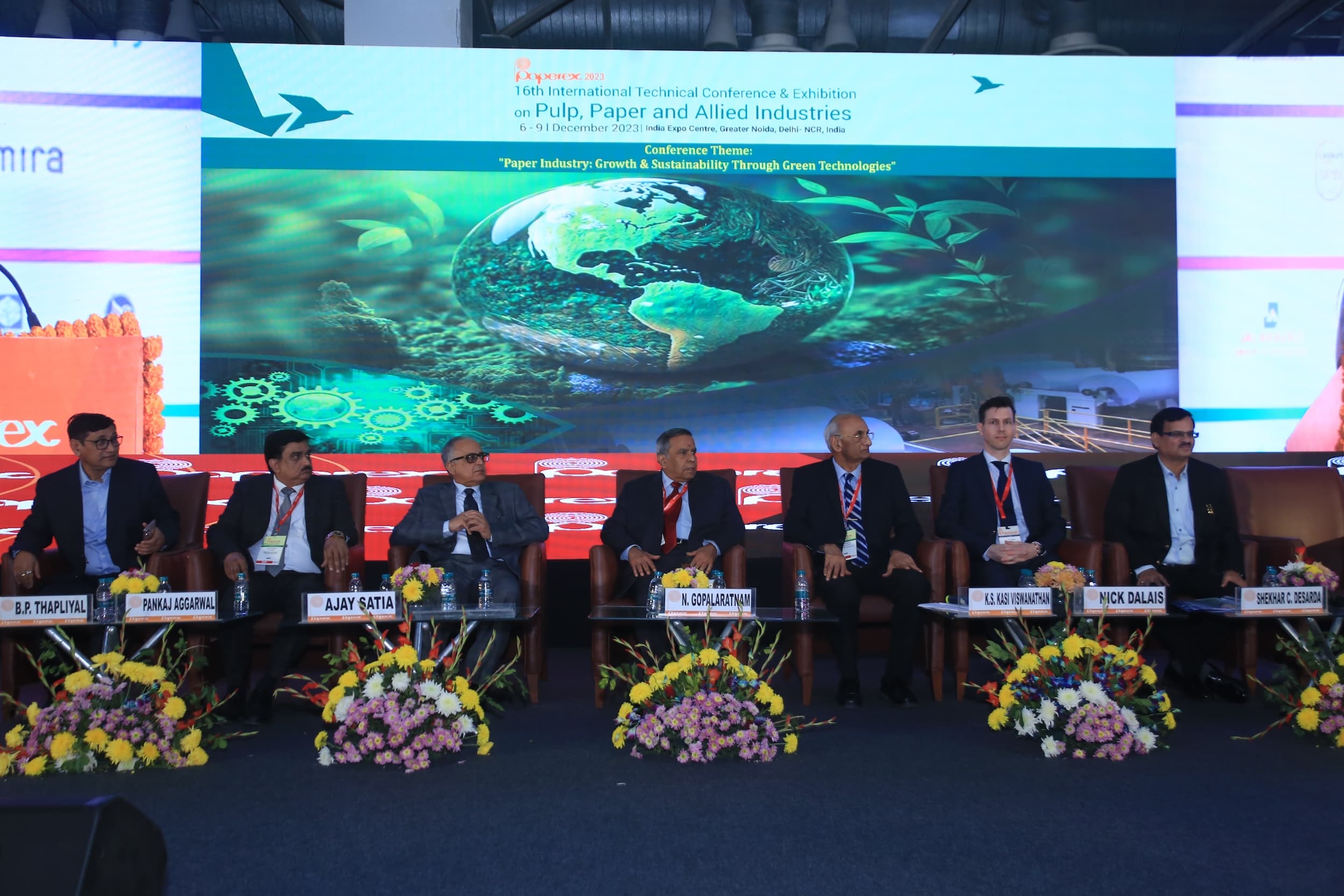 Panel discussion at a pulp and paper industry conference with speakers seated on stage.