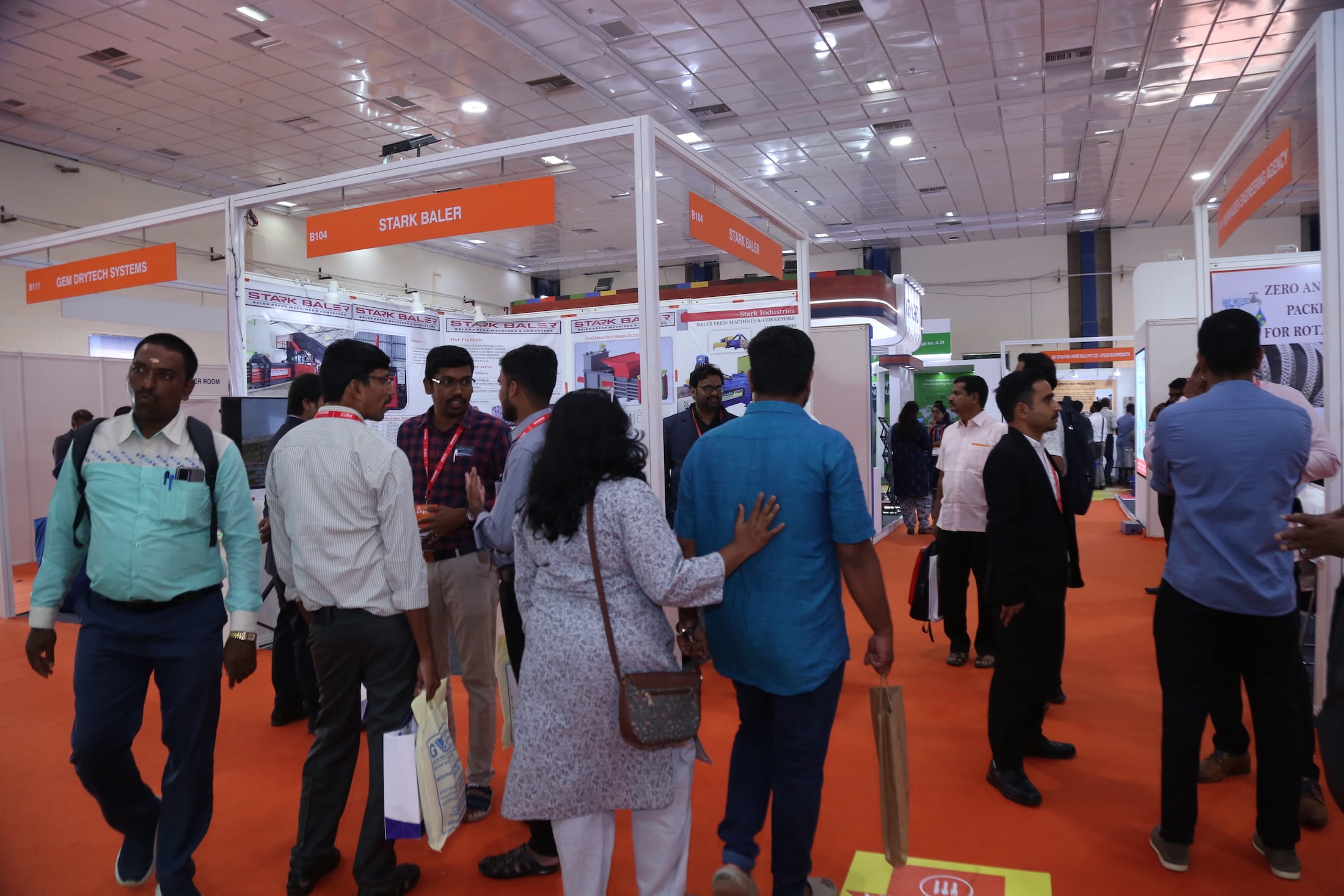 Attendees visiting vendor booths and engaging with exhibitors at Paperex South India.