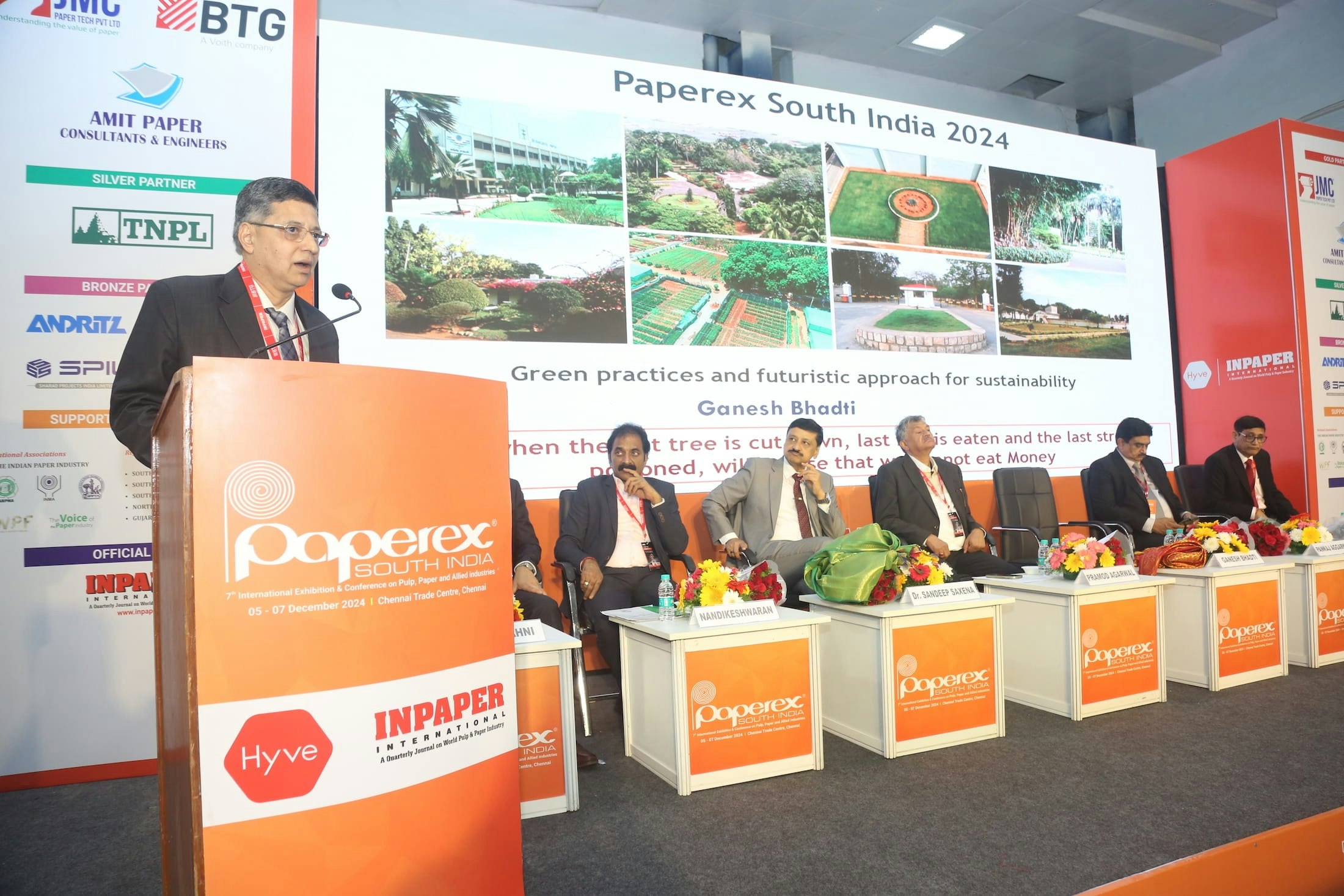 Conference panel at Paperex South India, featuring a keynote speaker at the podium and distinguished panelists on stage.