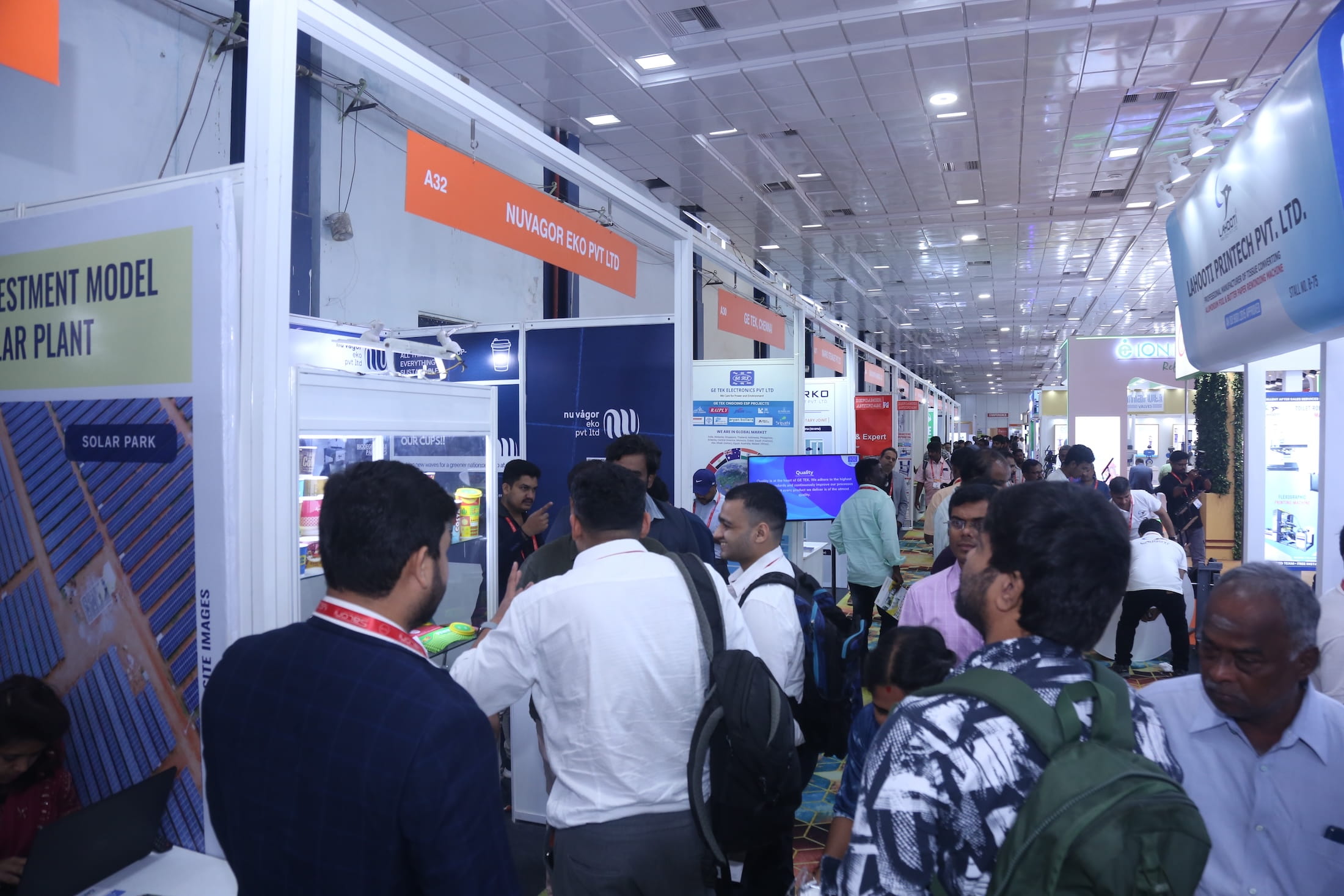 Attendees exploring exhibition booths and interacting with exhibitors at Paperex South India.