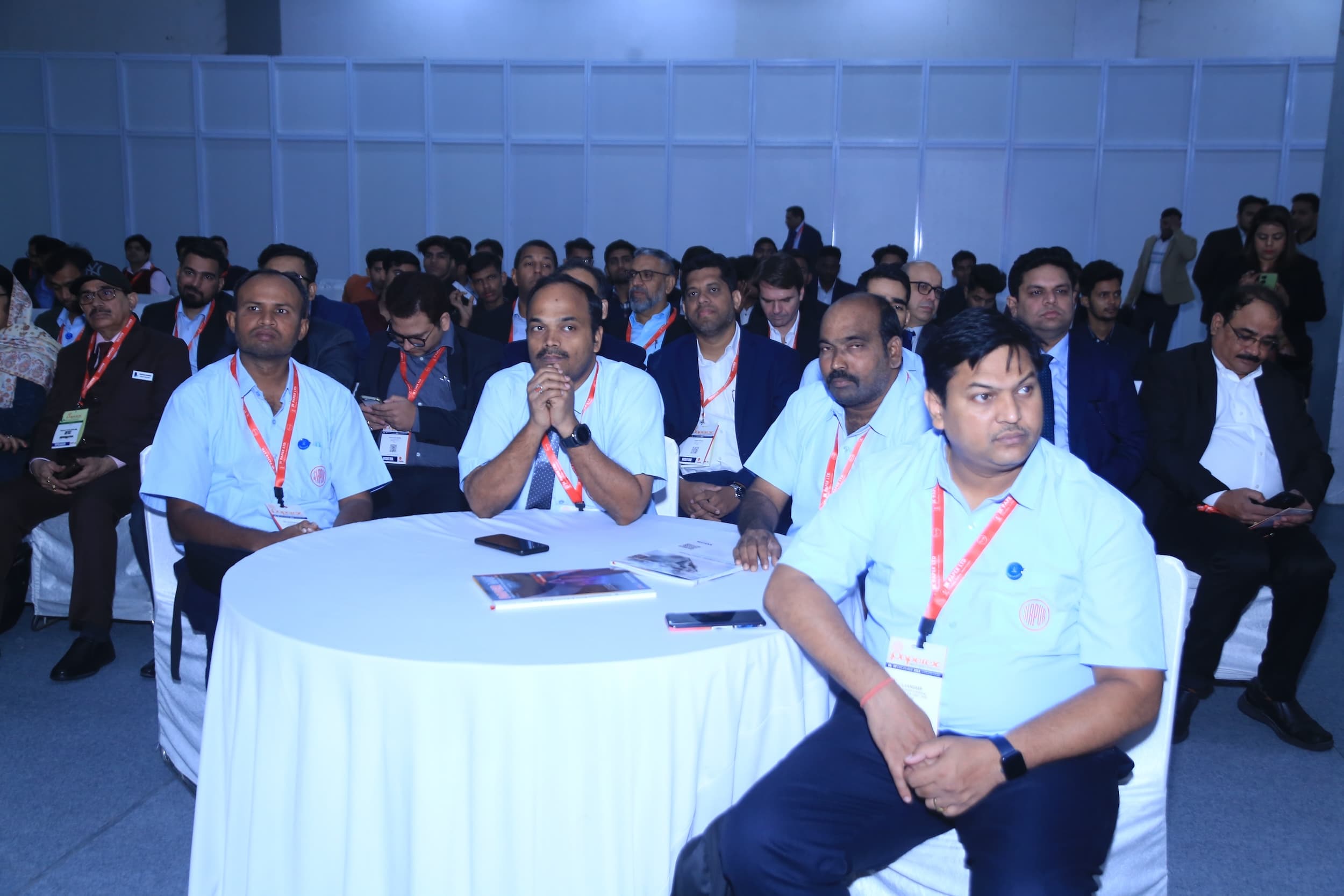 Attendees at a business conference or seminar seated at tables.