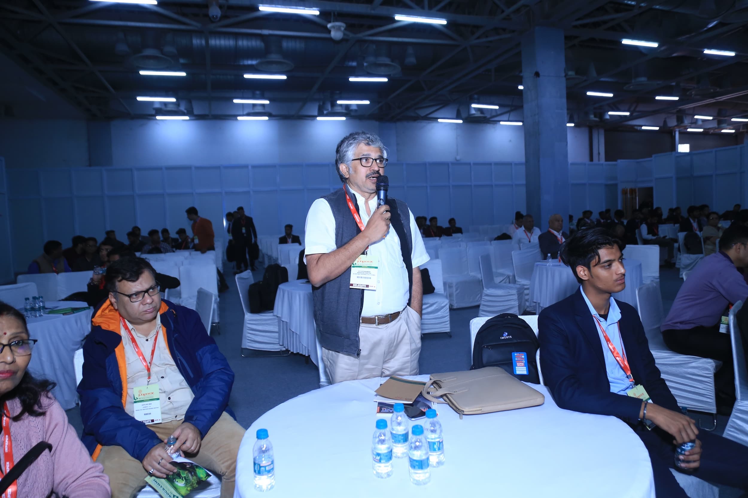 Man speaking with microphone at a conference or business event