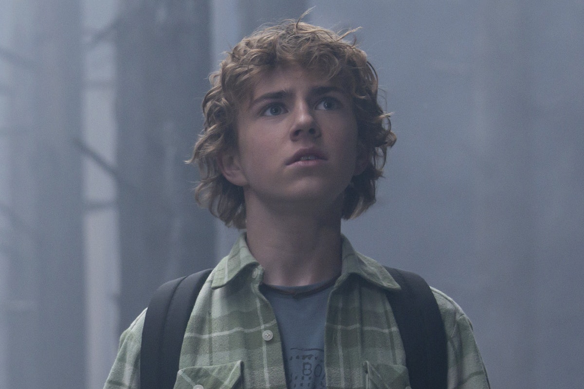 Percy Jackson looks concerned in the forest