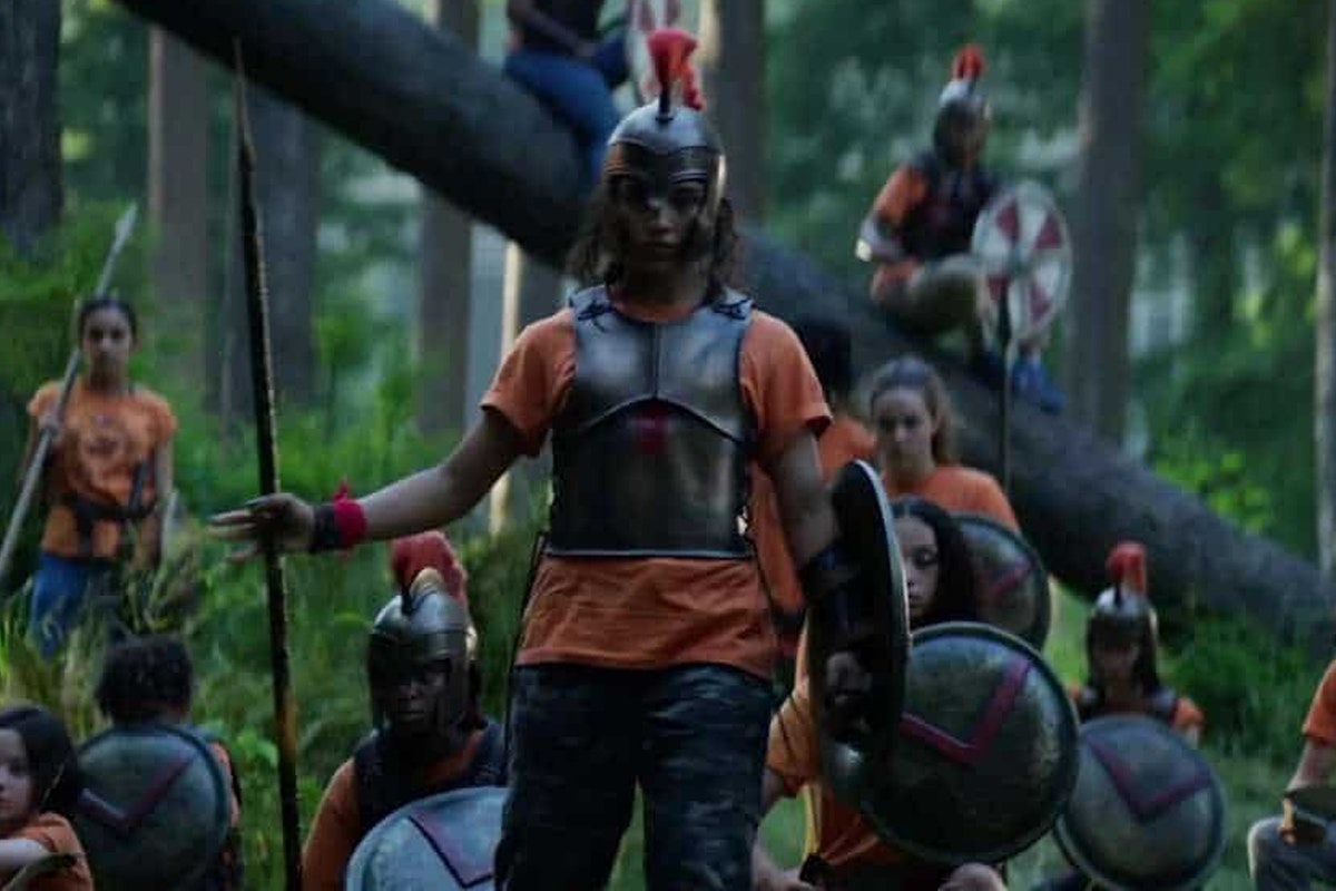 A group of campers stand in the forest